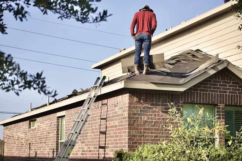 Professional roofer working on a residential roof in North Hobbs